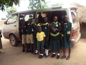 Pupils waiting to board mini bus to school